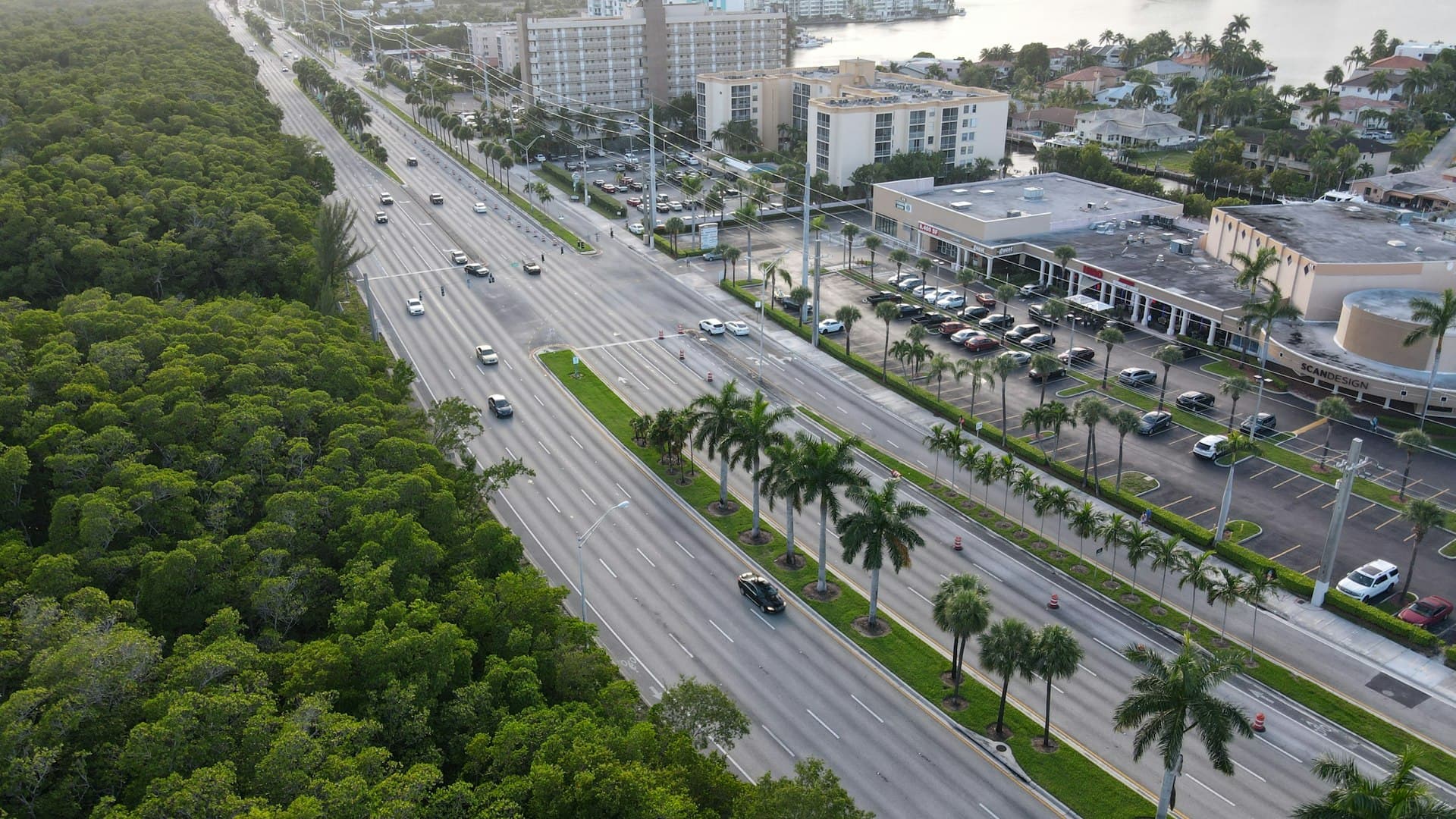 Florida commerce in motion: highways and buildings under the brand's cyan light.
